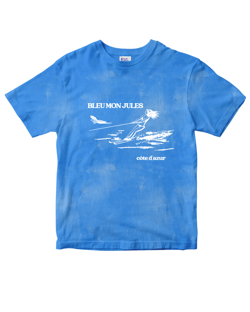 T-shirt bleu clair délavé Bleu mon Jules, dessin skieuse nautique et lettrage « Bleu mon Jules · Côte d'Azur », vue de face